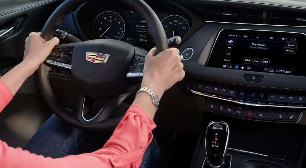 A person is shown steering a 2023 Cadillac XT4.