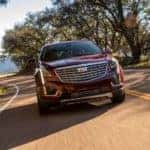 A red 2019 Cadillac XT5 is shown driving on an open road after leaving Cadillac Dealer in Atlanta GA.