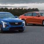 A blue 2023 Cadillac CT4-V and an orange 2023 Cadillac CT5-V are shown from the front.