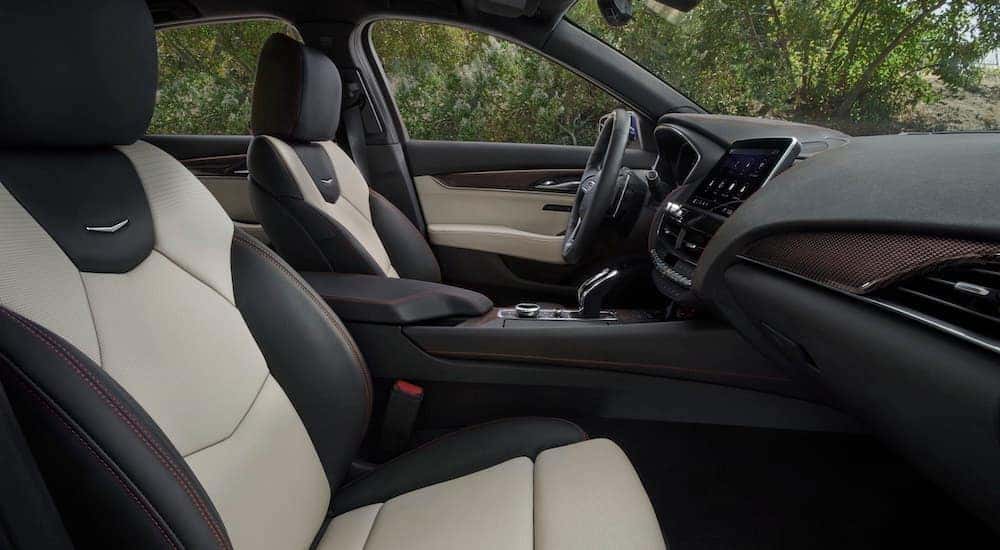The white interior of a 2021 Cadillac CT5-V is shown from the passenger side.