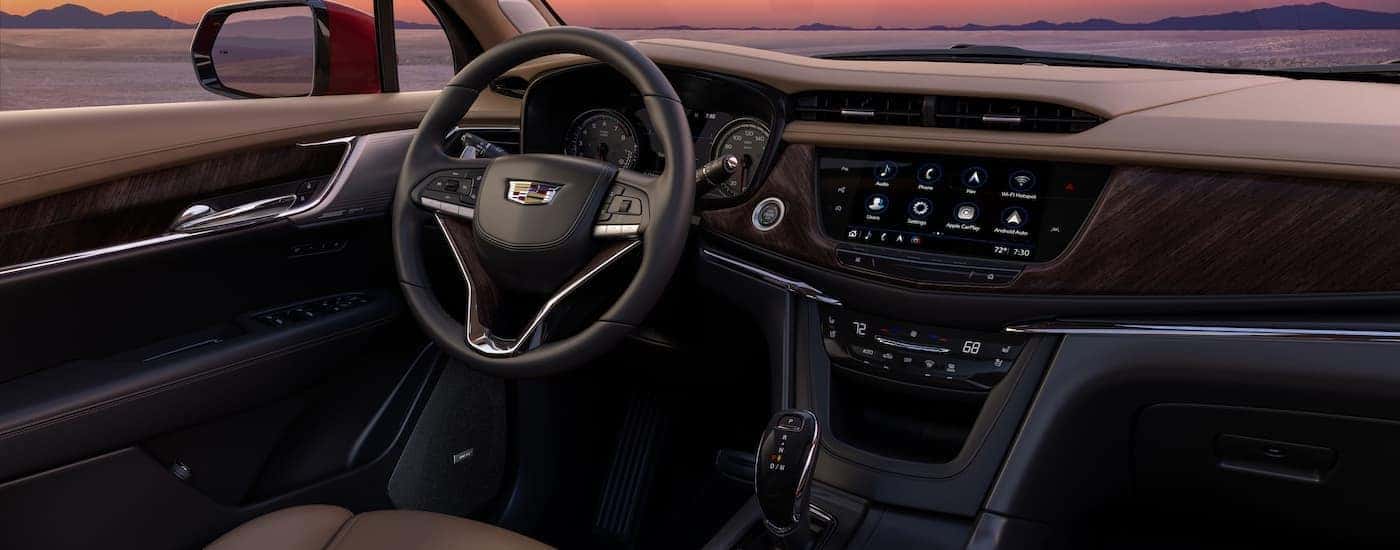 The brown interior of a 2023 Cadillac XT6 is shown from the passenger seat.