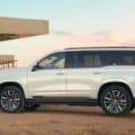 A white 2021 Cadillac Escalade is shown parked near a construction site.
