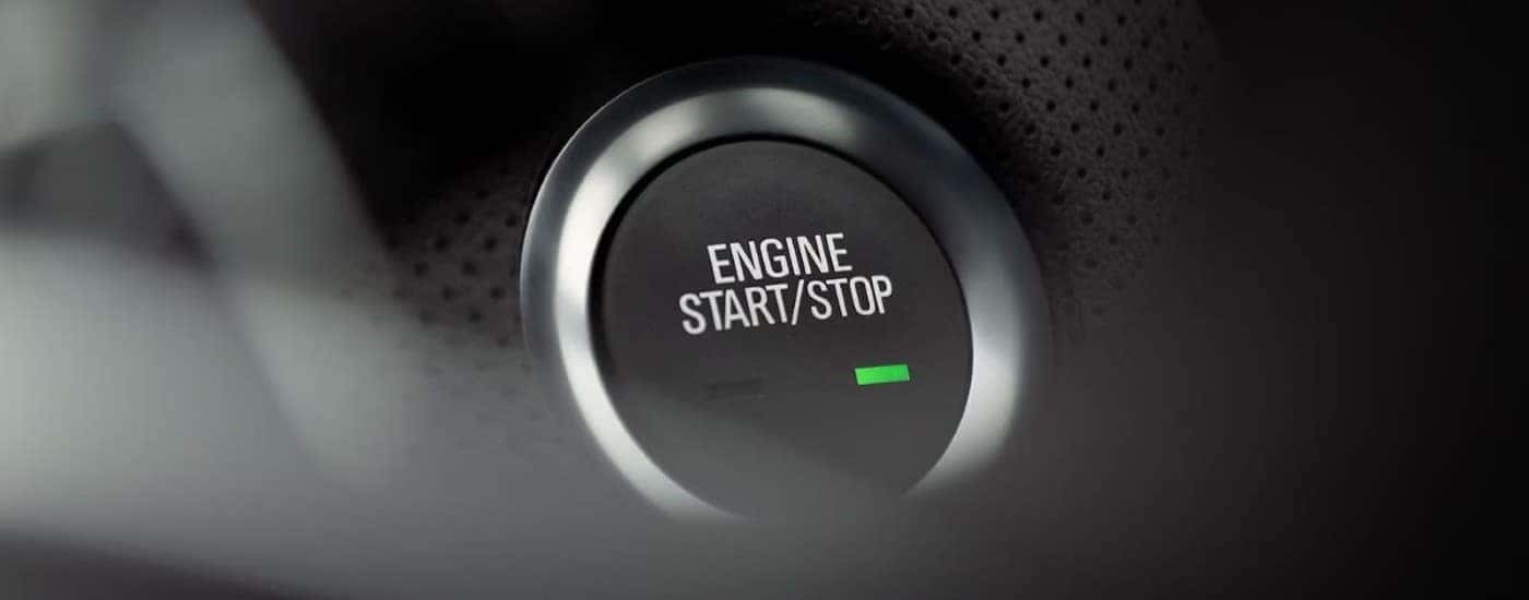 A close up shows the push button start/stop button in a 2023 Cadillac CT4.