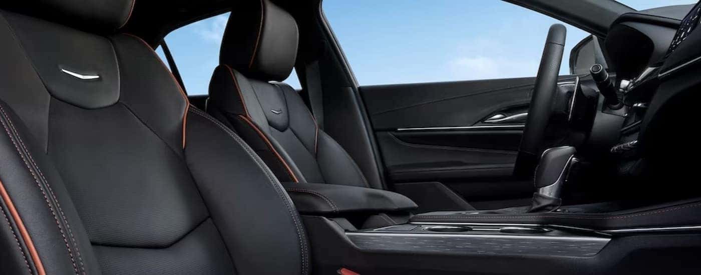 The black interior and dash of a 2024 Cadillac CT4 is shown.