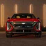 A red 2024 Cadillac LYRIQ is shown parked near a Buckhead Cadillac dealer.