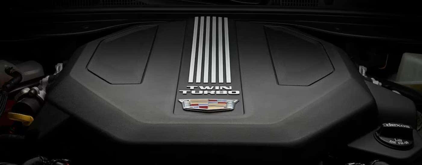 A close-up of a twin turbo engine in a 2025 Cadillac CT5 is shown.