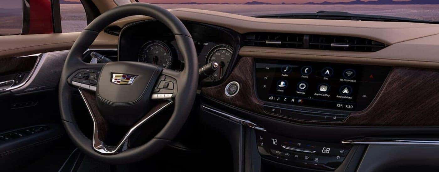 The steering wheel and infotainment screen are shown in a 2024 Cadillac XT6.