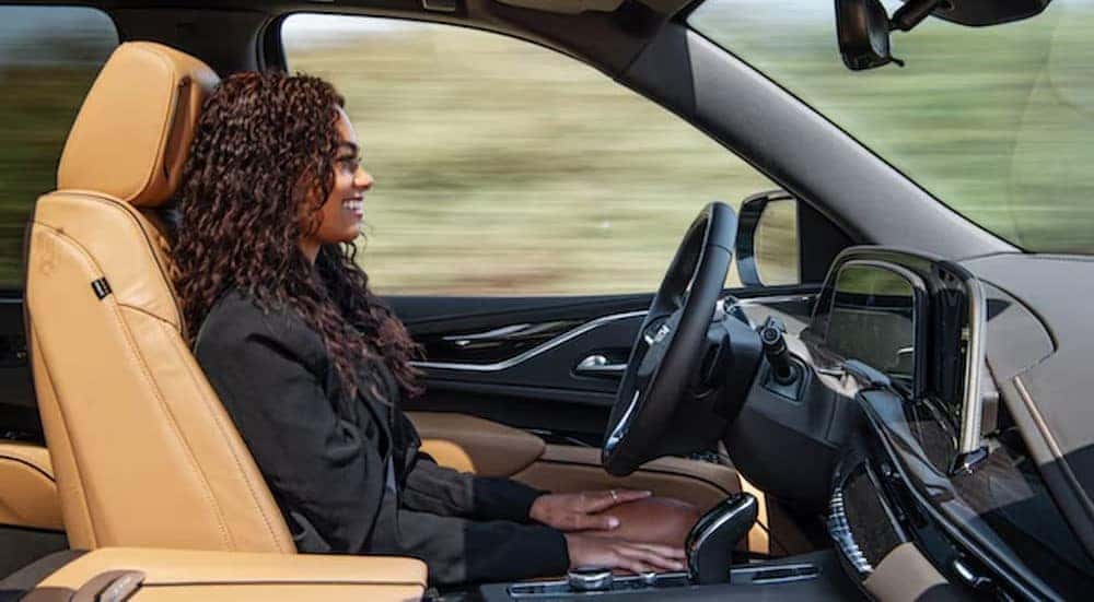 A person is shown using Super Cruise in a Cadillac.