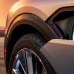 A close-up of the charging port on a silver 2024 Cadillac LYRIQ.