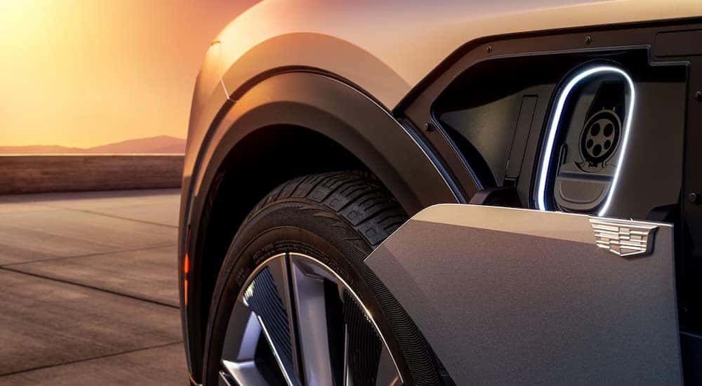 A close-up of the charging port on a silver 2024 Cadillac LYRIQ.