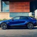 A blue 2024 Cadillac LYRIQ for sale is shown parked and charging.