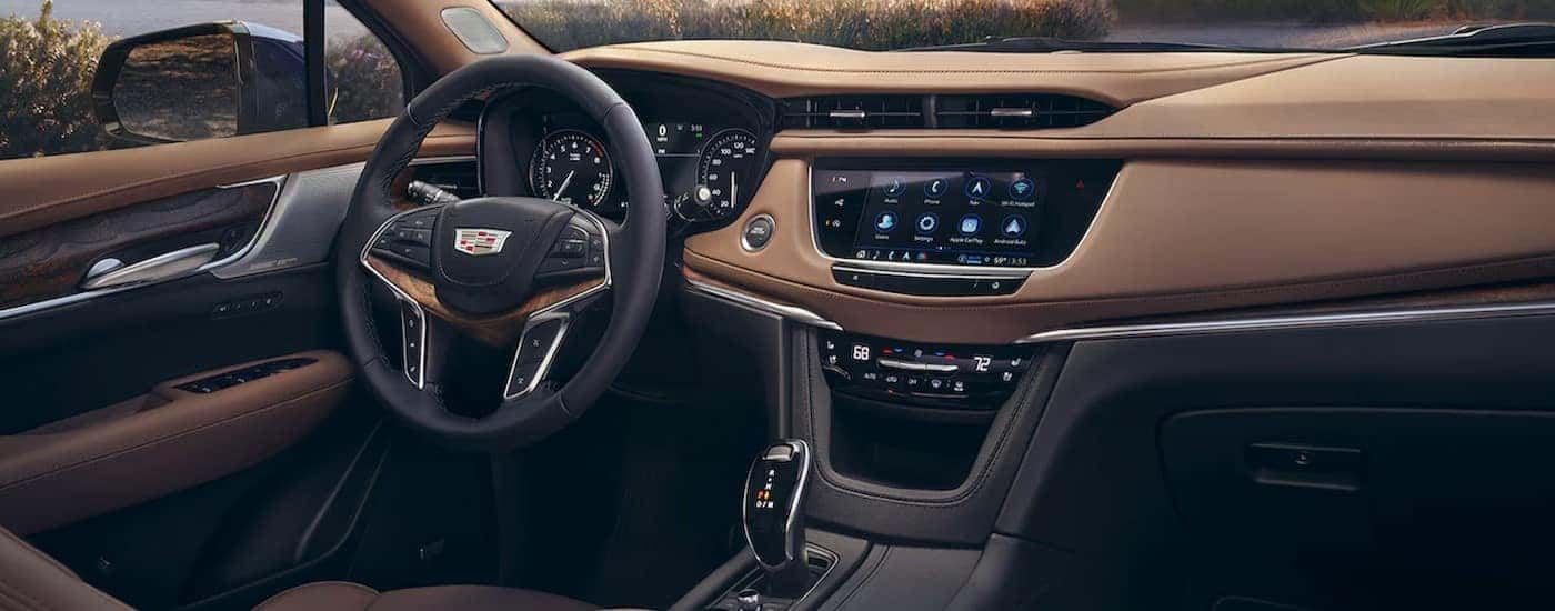 The black and brown interior and dash in a 2024 Cadillac XT5 is shown.
