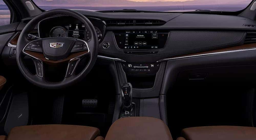 The gray and tan interior and dash in a 2024 Cadillac XT6 is shown.