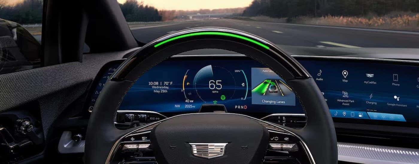 A close-up of the digital dash in a 2025 Cadillac OPTIQ is shown.