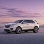 A white 2023 Cadillac XT5 is shown from the side after leaving a used Cadillac dealer.
