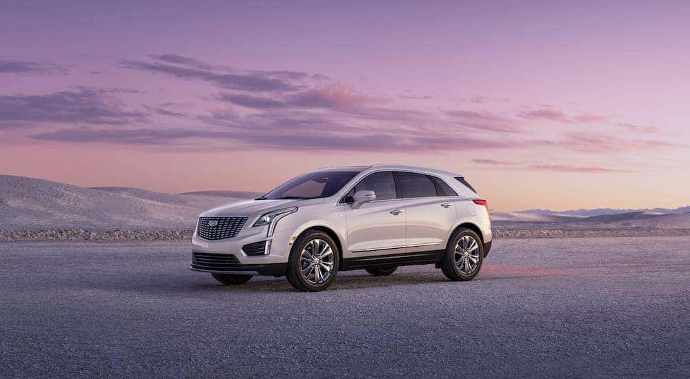 A white 2023 Cadillac XT5 is shown from the side after leaving a used Cadillac dealer.