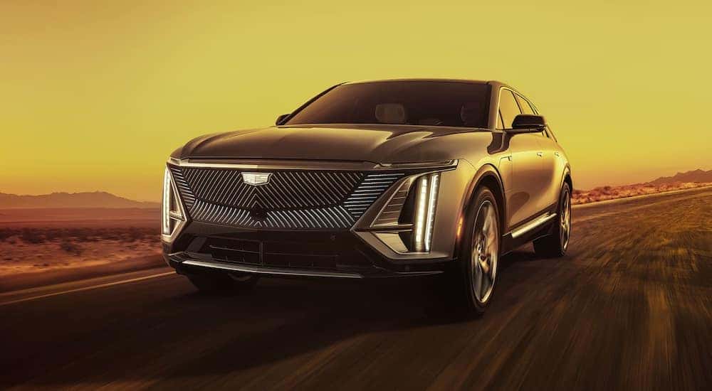 A grey 2024 Cadillac LYRIQ for sale near Marietta driving down a road.