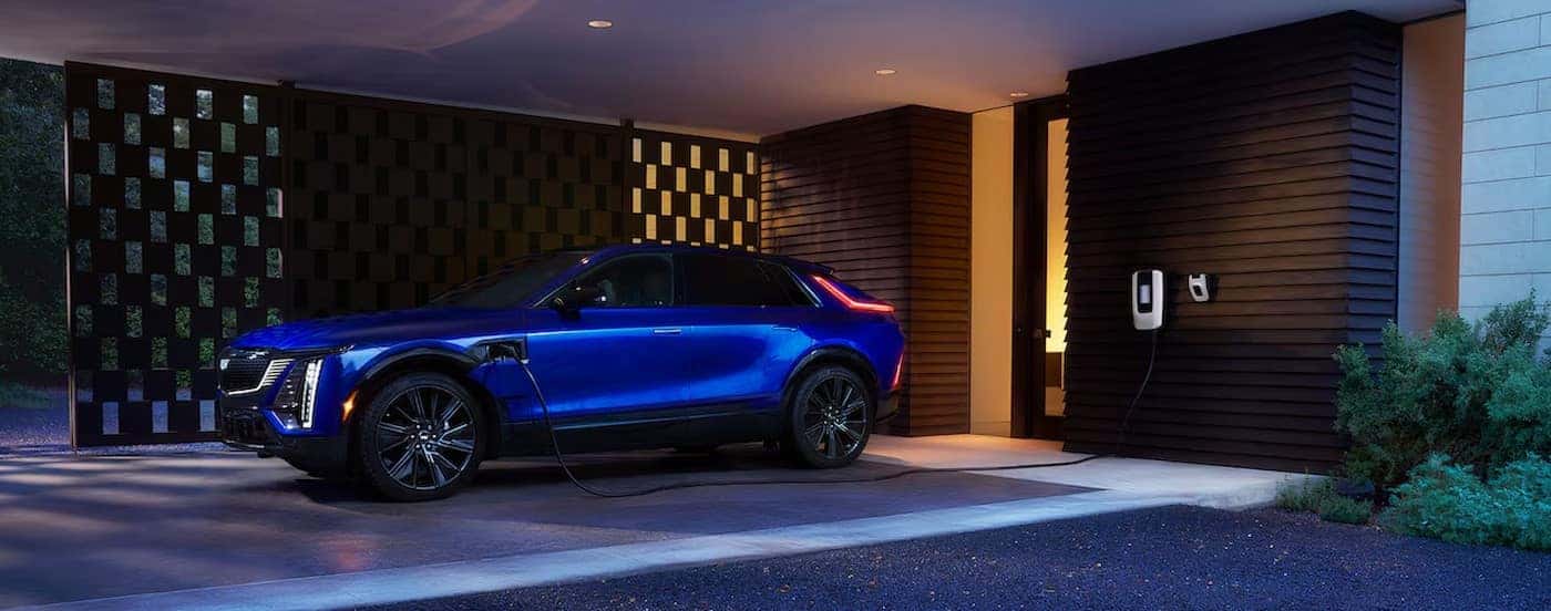 A blue 2025 Cadillac LYRIQ is shown charging.