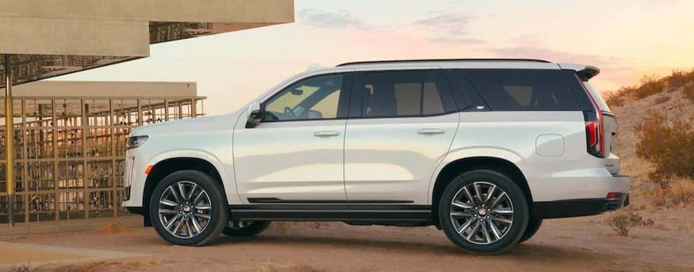 A white 2021 Cadillac Escalade is shown parked on dirt.