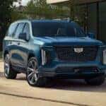 A blue 2025 Cadillac Escalade is shown parked after visiting a Cadillac dealer near Milton.