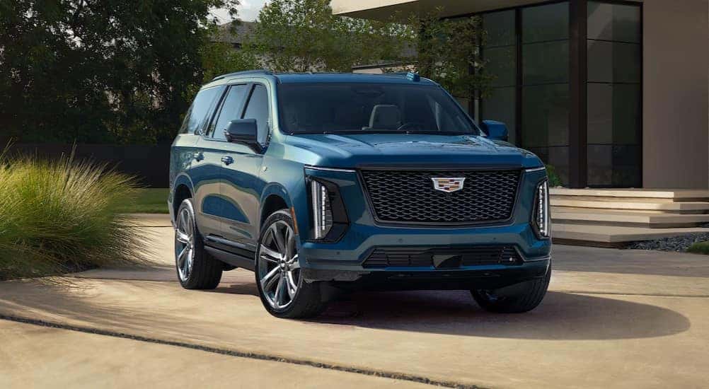 A blue 2025 Cadillac Escalade is shown parked after visiting a Cadillac dealer near Milton.
