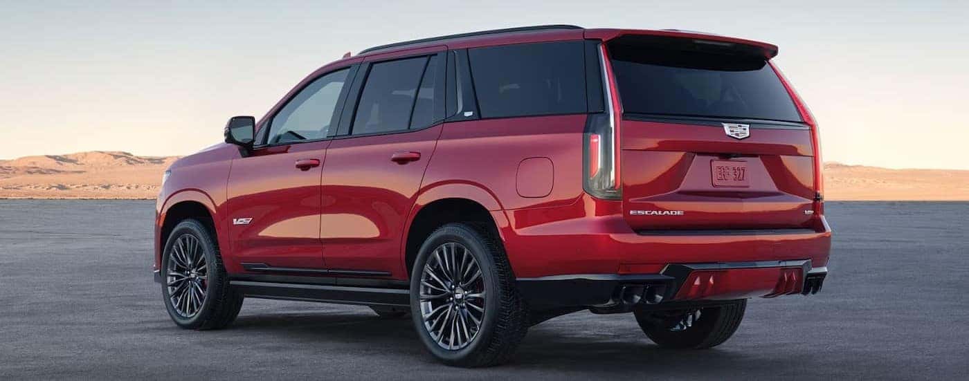 A red 2025 Cadillac Escalade-V is shown parked on a sunny day.