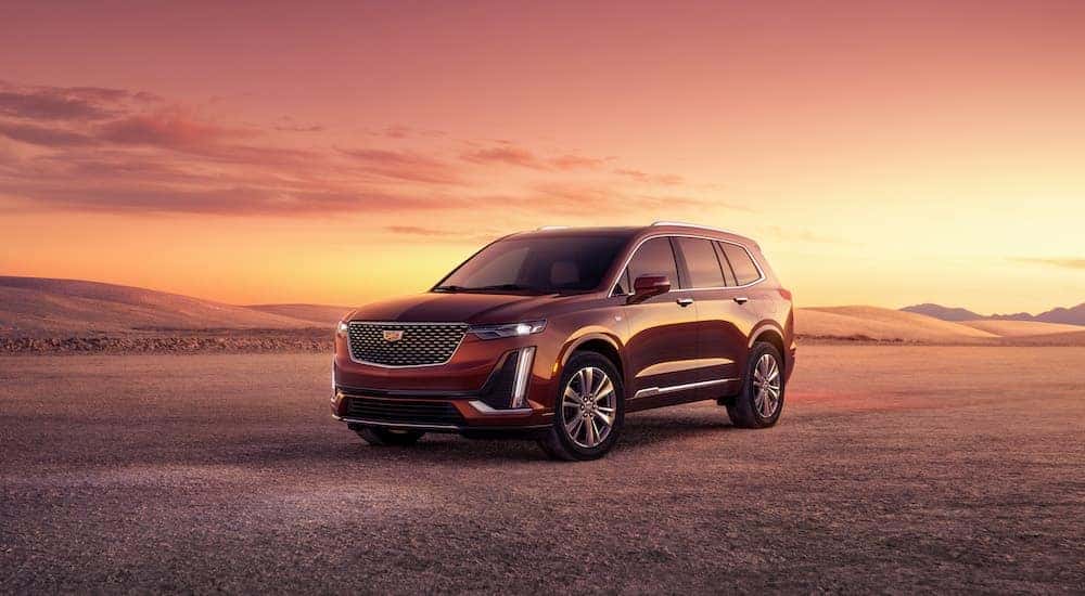 A maroon 2023 Cadillac XT6 is shown from the front at an angle.