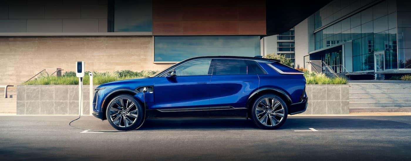 A blue 2025 Cadillac LYRIQ is shown charging.