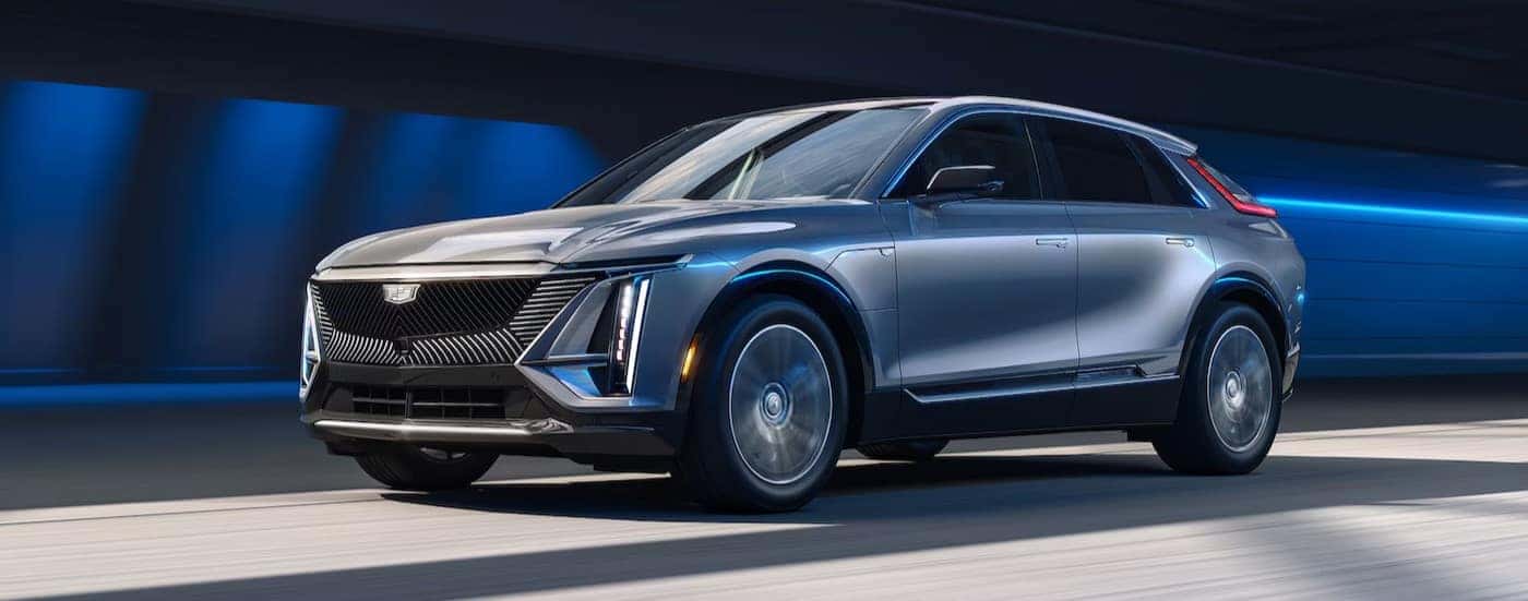 A silver 2025 Cadillac LYRIQ is shown driving fast in a tunnel.