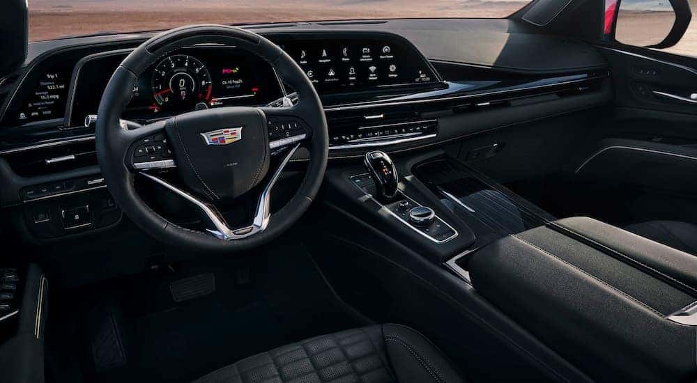 The black interior of a 2023 Cadillac Escalade is shown from the drivers seat after leaving a dealer that has used Cadillac for sale.