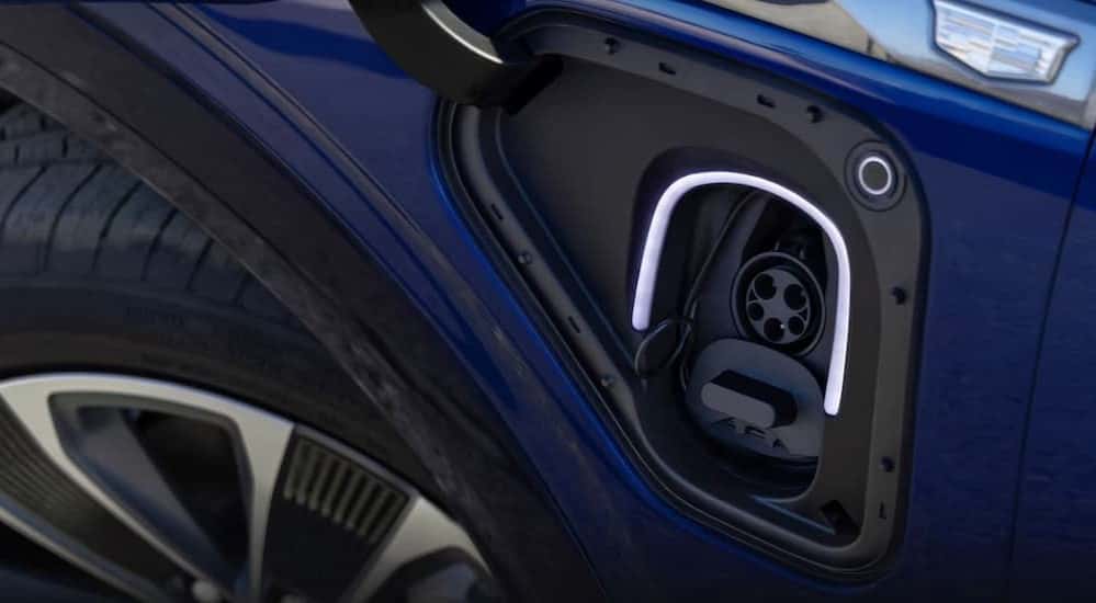 A close-up of a charging port is shown on a 2026 Cadillac VISTIQ.