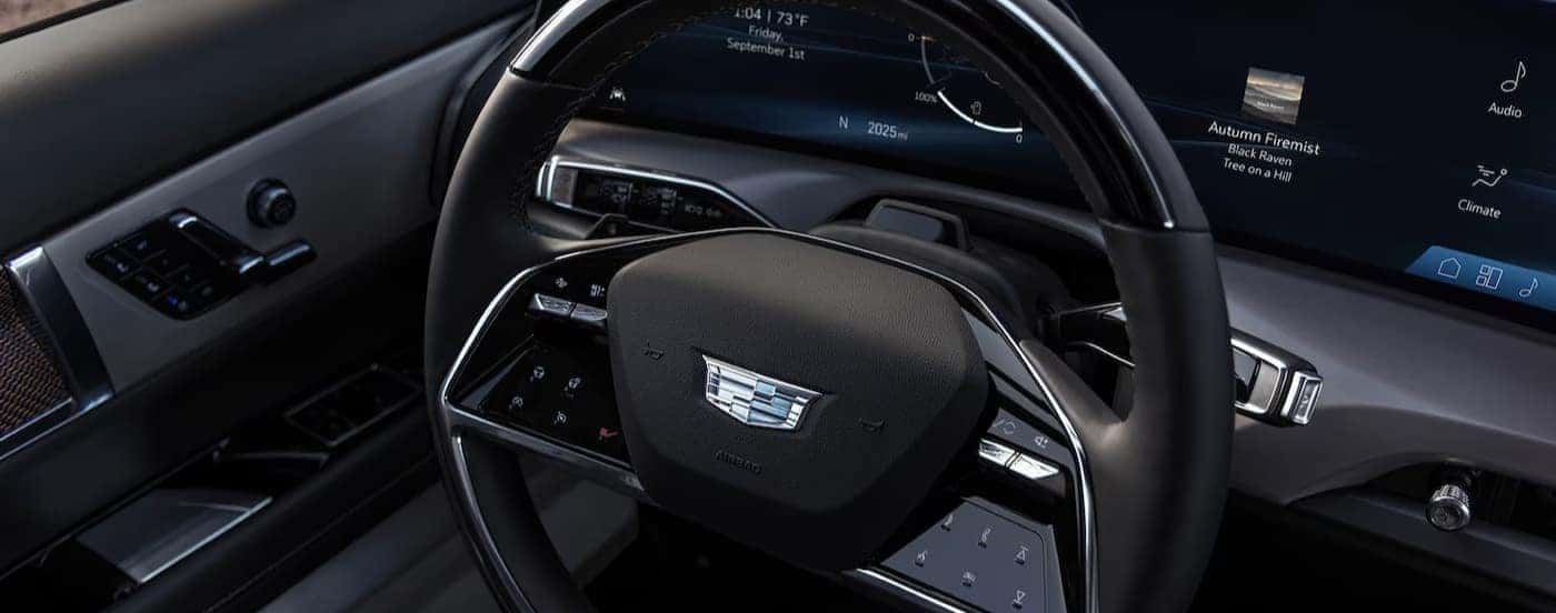 A close-up of the steering wheel is shown in a 2026 Cadillac VISTIQ.