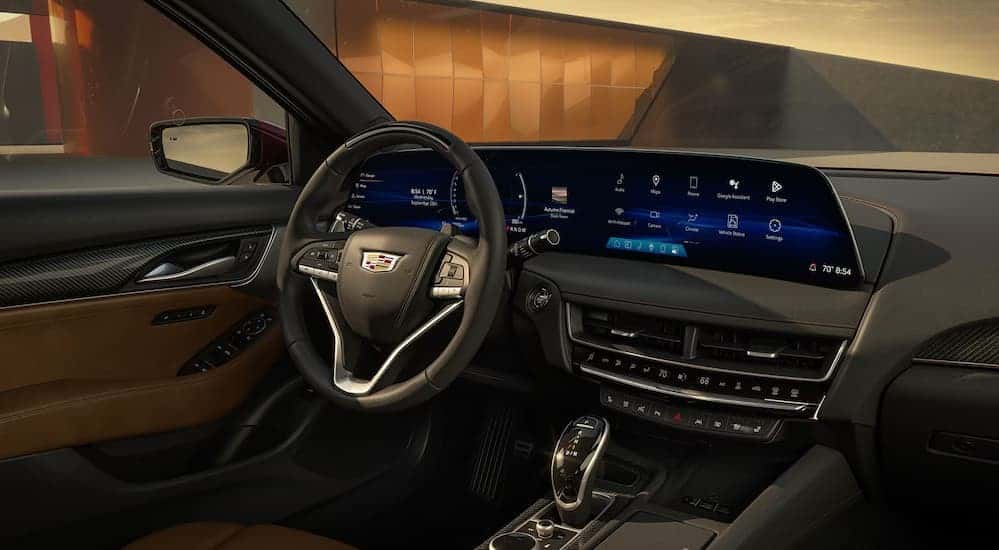 The black and brown interior and dash are shown in a 2025 Cadillac CT5.