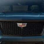 Close-up on the grille and badging of a blue 2025 Cadillac Escalade.