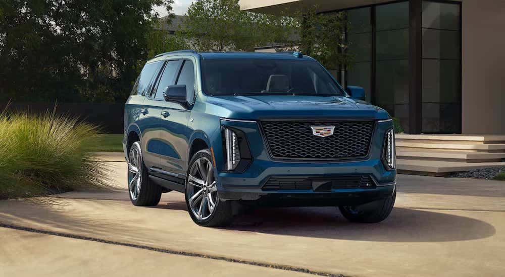 A blue 2025 Cadillac Escalade for sale in Atlanta parked on a driveway.