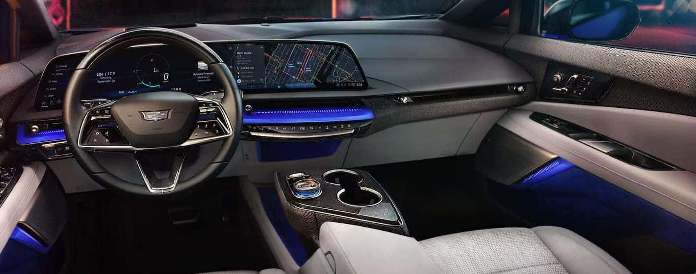 The gray and white interior and dash are shown in a 2025 Cadillac OPTIQ.