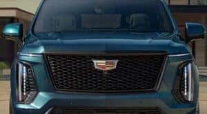 A close-up of the front end of a green 2025 Cadillac Escalade is shown.