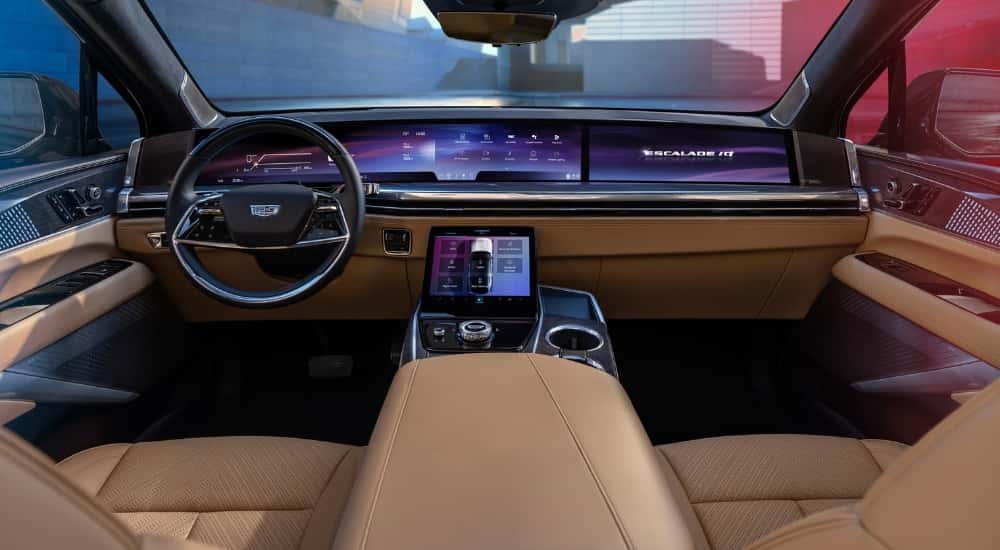 A tan 2025 Cadillac Escalade IQ is shown from above the center console.
