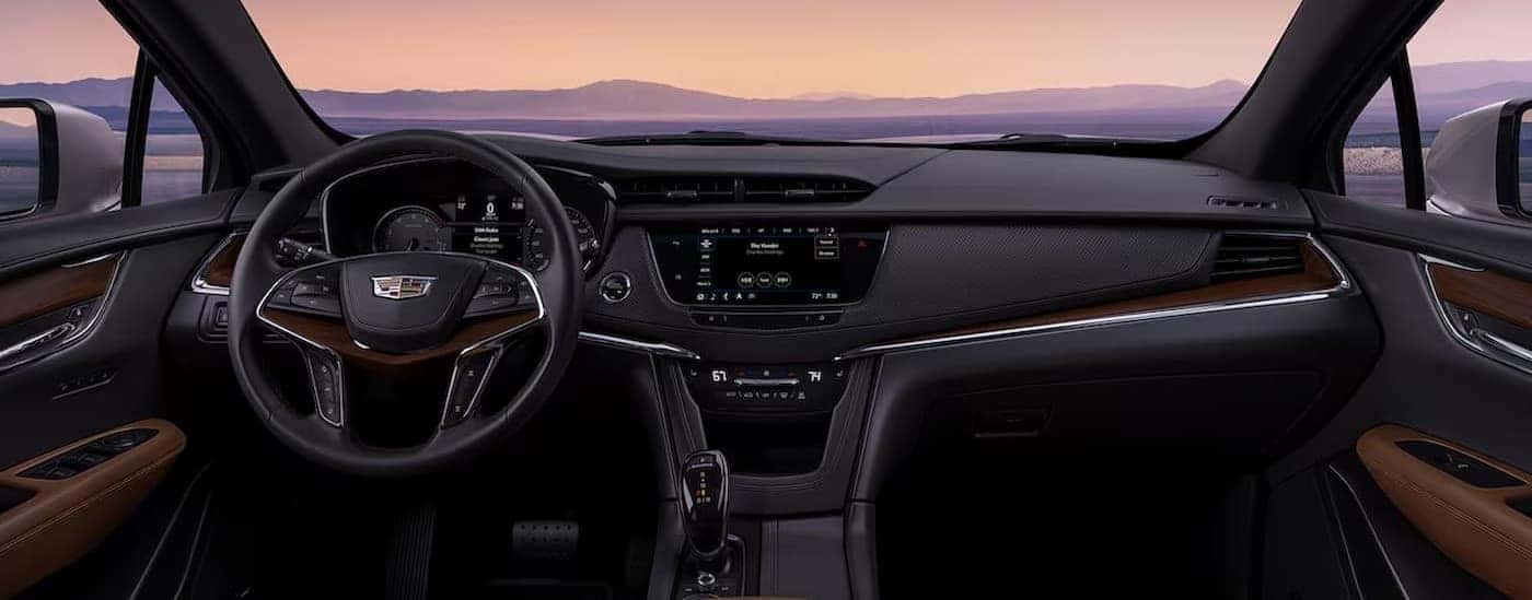 The black dashboard is shown in a 2025 Cadillac XT5.