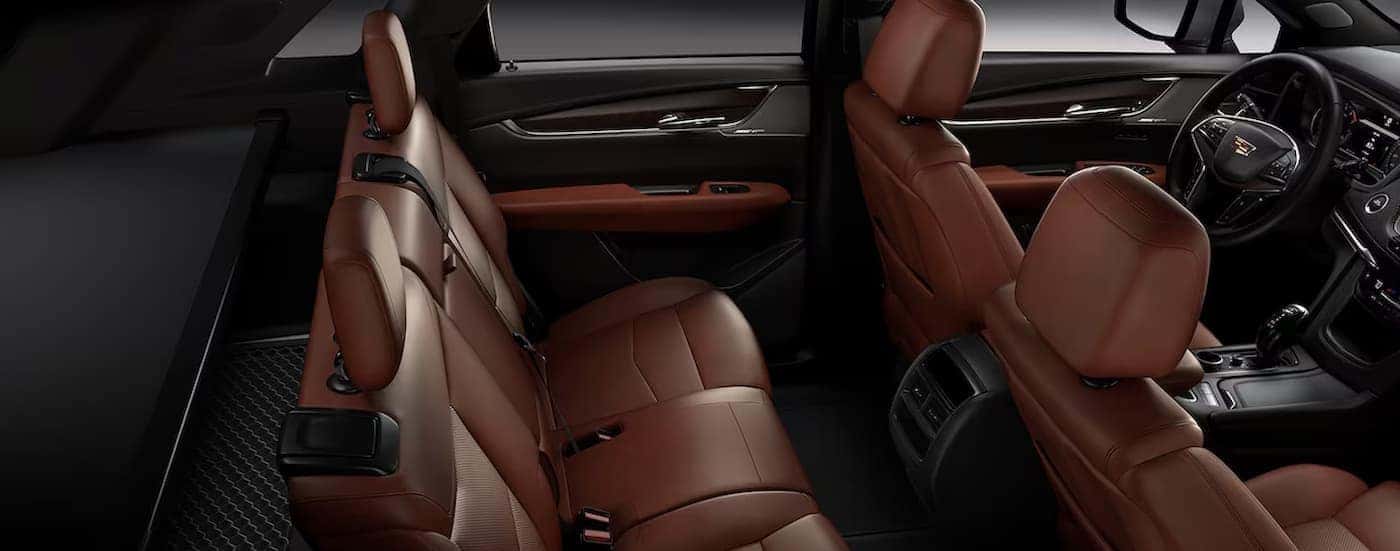 The black and brown interior and dash are shown in a 2025 Cadillac XT5.