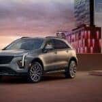 A silver 2025 Cadillac XT4 parked near skyscrapers.