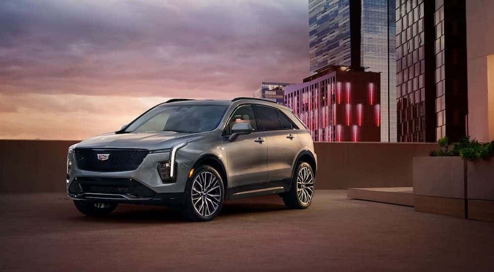 A silver 2025 Cadillac XT4 parked near skyscrapers.