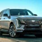 A silver 2026 Cadillac Escalade IQL parked on a driveway.