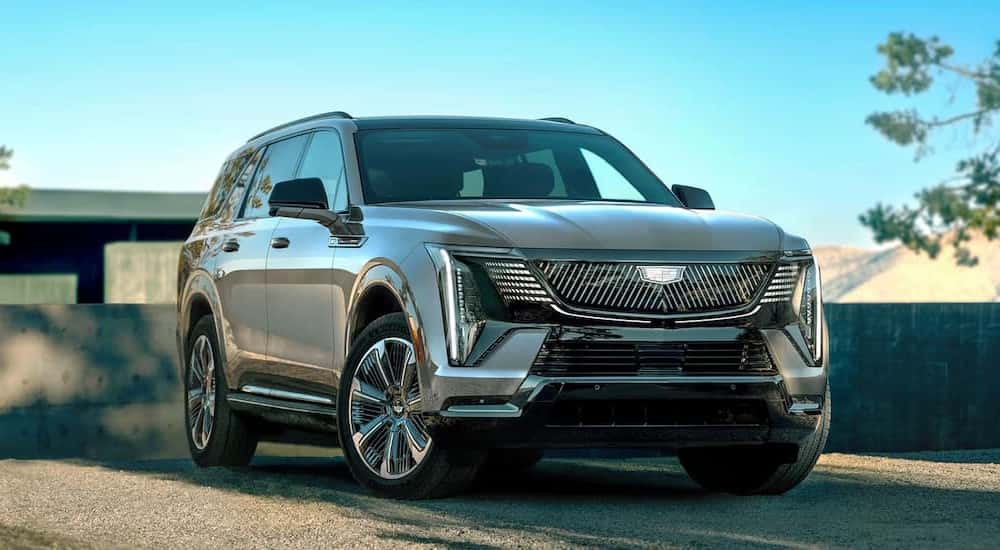 A silver 2026 Cadillac Escalade IQL parked on a driveway.