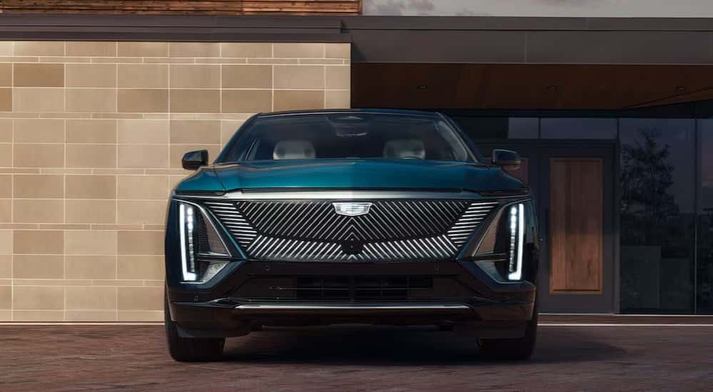 A green 2025 Cadillac LYRIQ parked on a driveway.