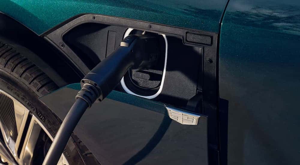 A green 2025 Cadillac LYRIQ Luxury 1 is charging.