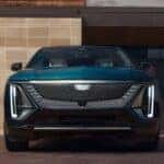 A green 2025 Cadillac LYRIQ Luxury 1 parked on a driveway.