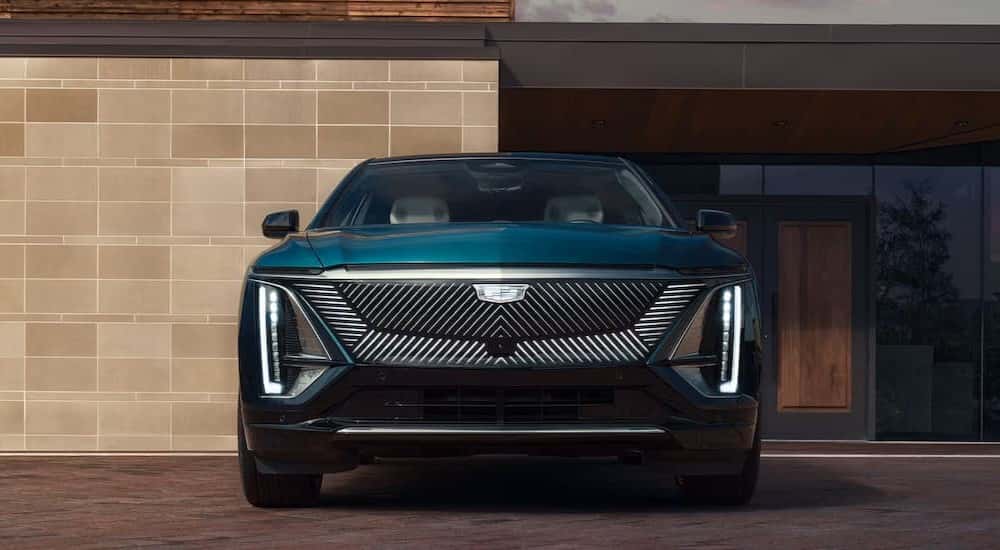 A green 2025 Cadillac LYRIQ Luxury 1 parked on a driveway.