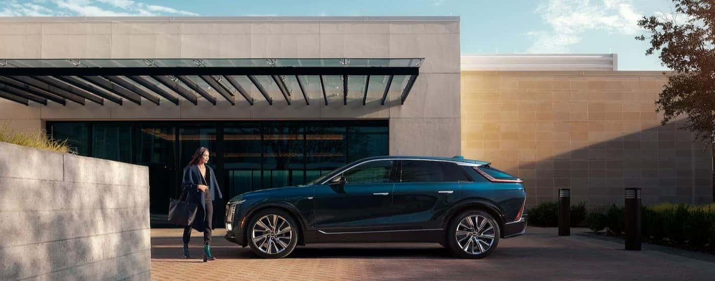 A green 2025 Cadillac LYRIQ Luxury 1 parked on a driveway.