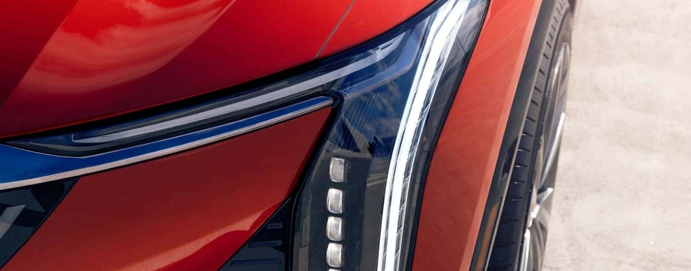 Driver side headlight on a red 2025 Cadillac OPTIQ.